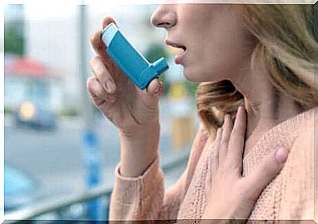 A woman with an asthma inhaler. 