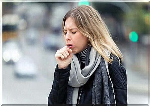 A coughing woman affected by the coronavirus